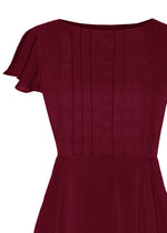 burgundy dress with pleated bodice and full skirt